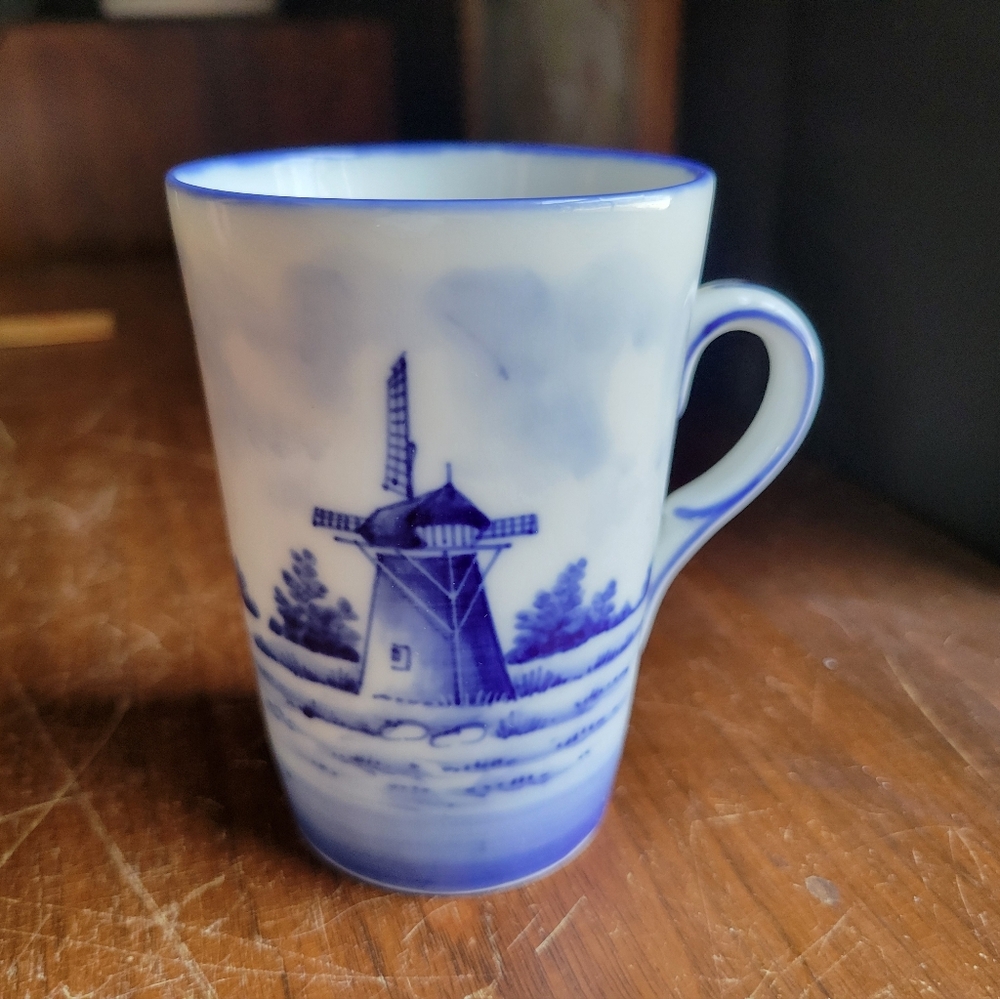 Delft style cobalt blue and white porcelain coffee mug featuring a windmill...